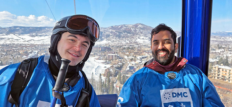 Two men pose in a ski lift