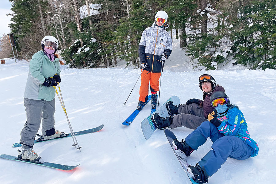People pose in ski gear in the snow