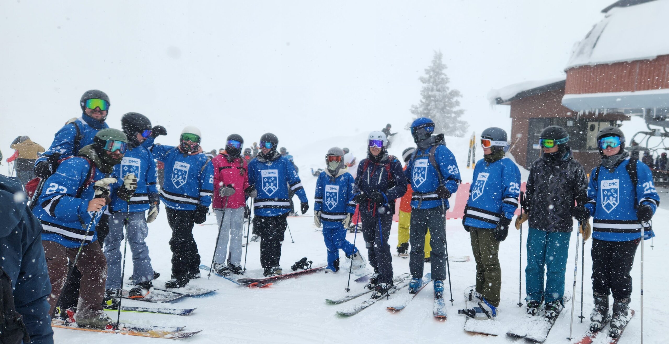 DMC coworkers posing together at the top of a ski slope in Denver, CO.