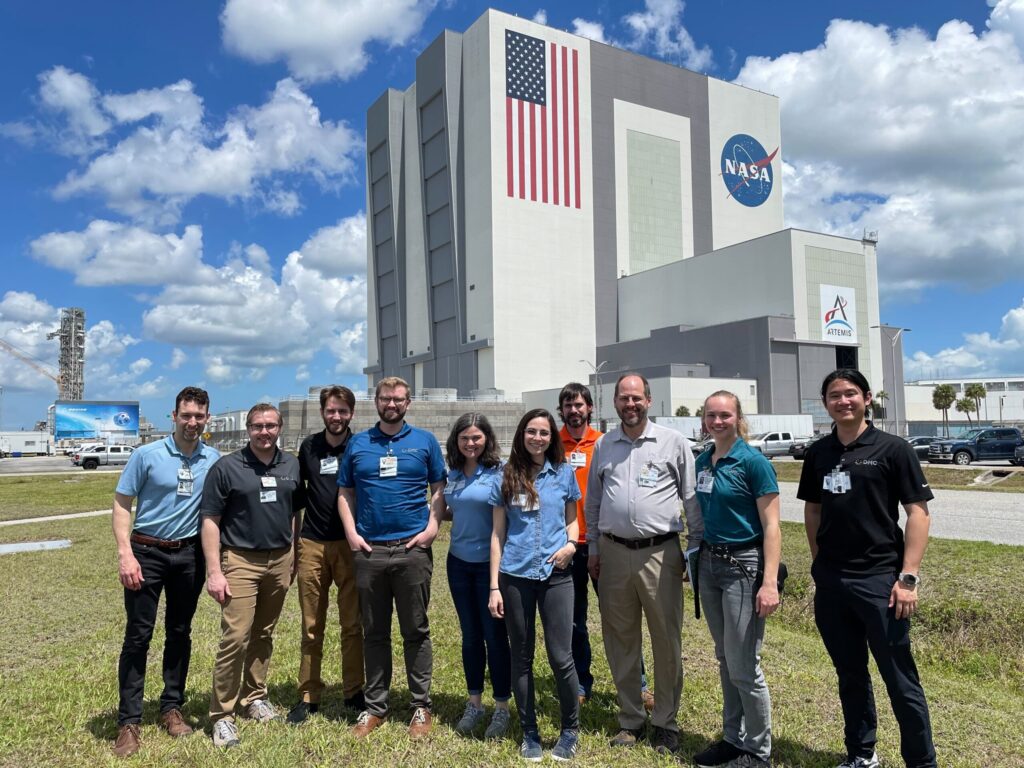 DMC engineers standing in front of the NASA building in Cape Canaveral.