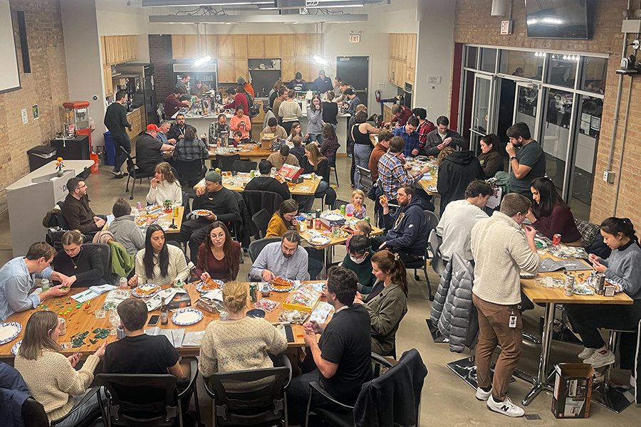 Image of DMC employees in the office kitchen participating in last year's LEGO activity.