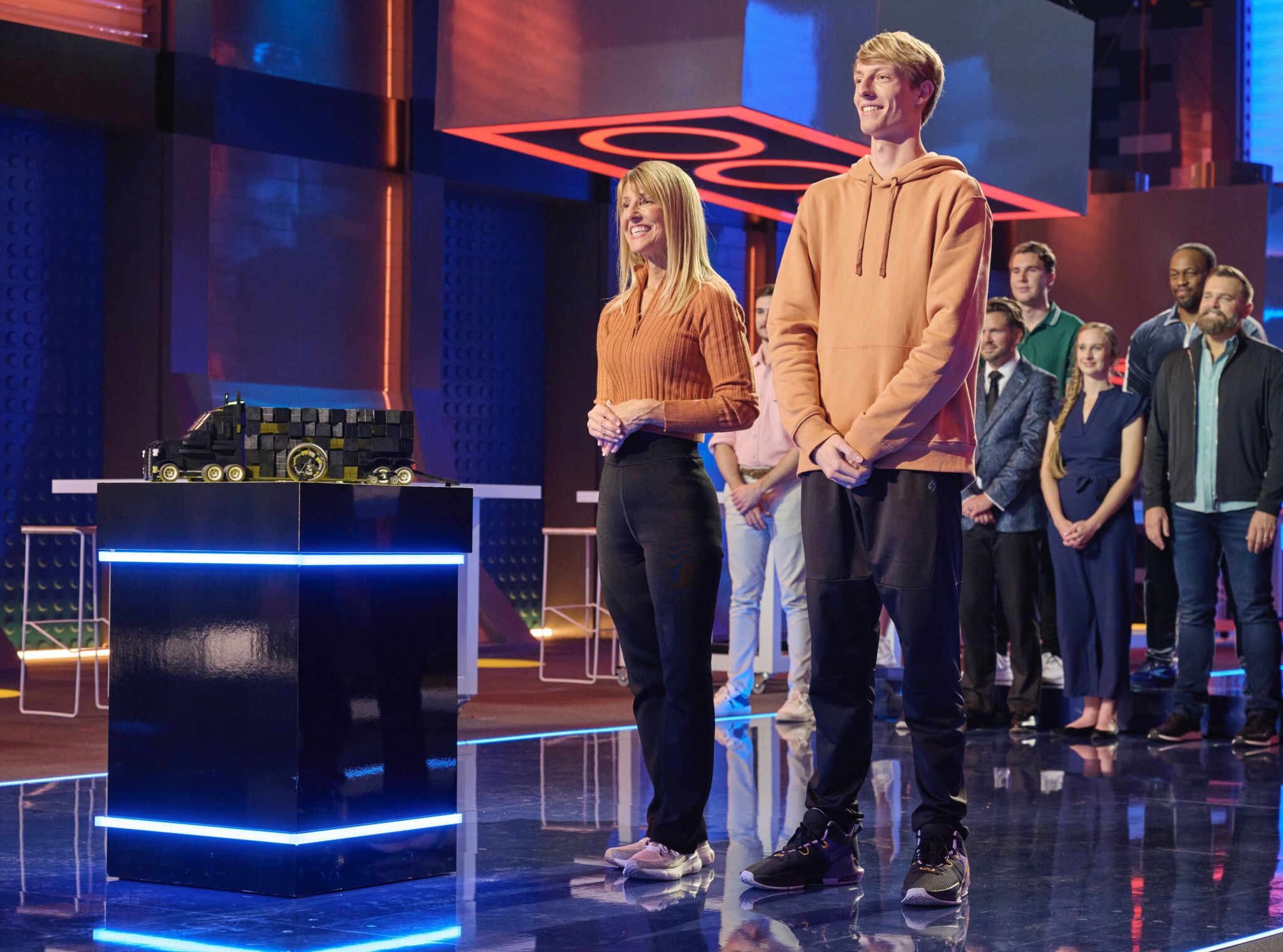 DMC engineer, Luke Horwath, and Anne standing next to their design on Lego Masters, Season 5.