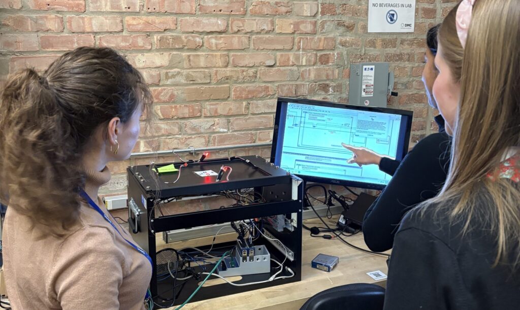 Engineering students interacting with NI cDAQ hardware and software to complete a test and measurement activity.