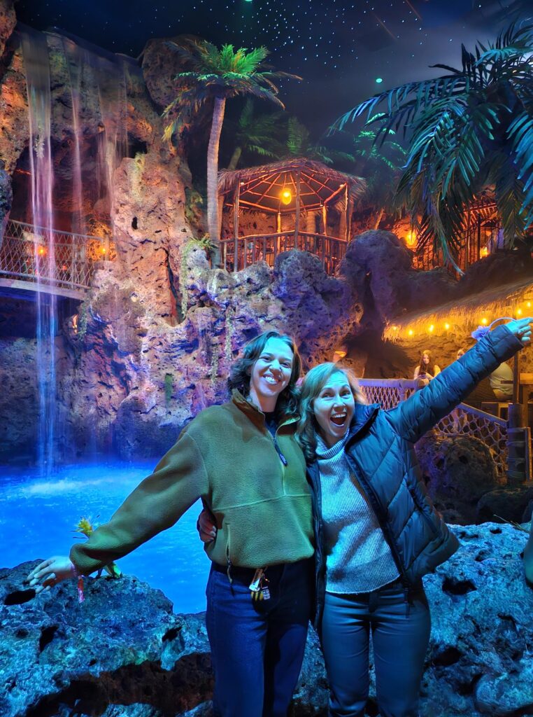 Two DMC team members posing in front of Casa Bonita's cliffs.