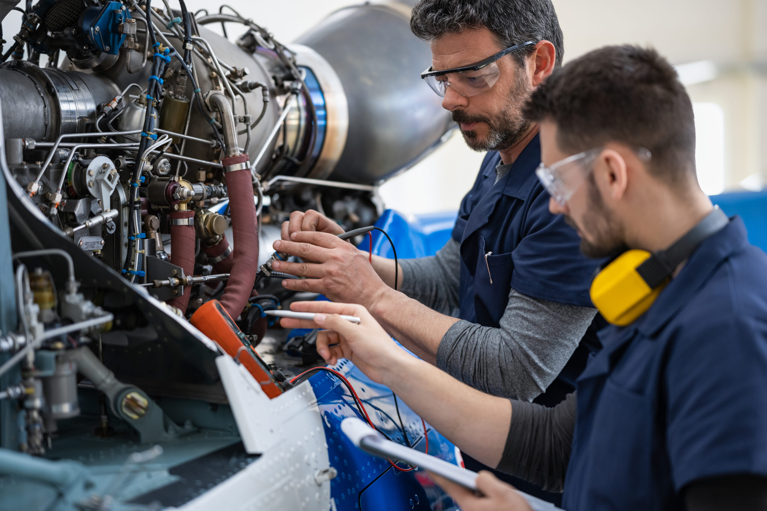 Engineers working on an airplane part