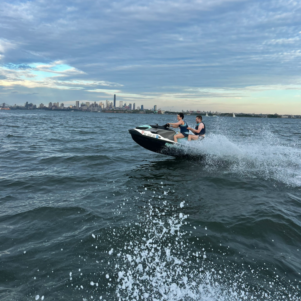 Two DMC team members on a jet ski