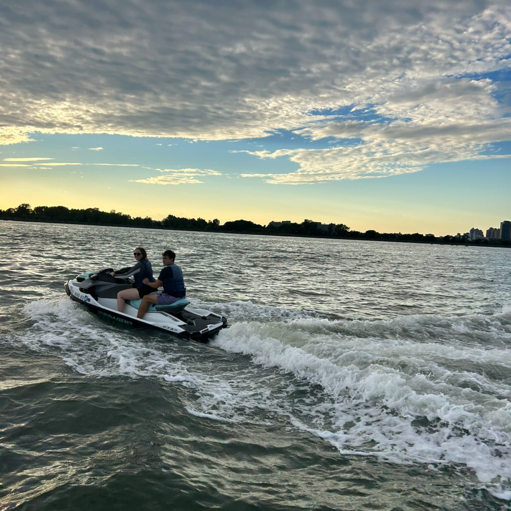 DMC NY team members on a jet ski at sunset
