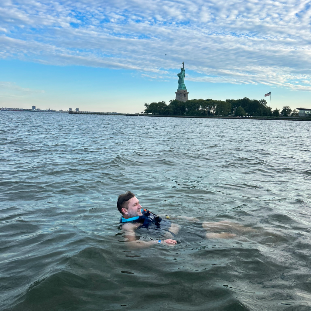 DMC employee in the New York Harbor with Statue of Liberty in the background