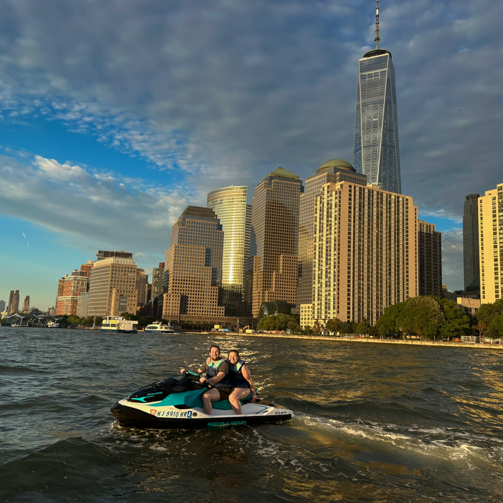 DMC team members on jet skis with Battery Park in the background