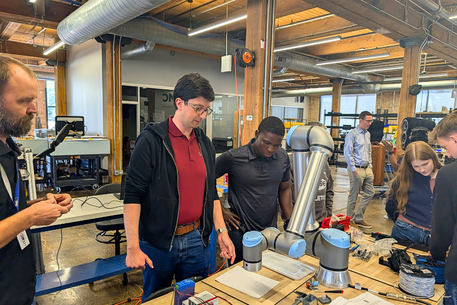 DMC engineers working on a cobot project