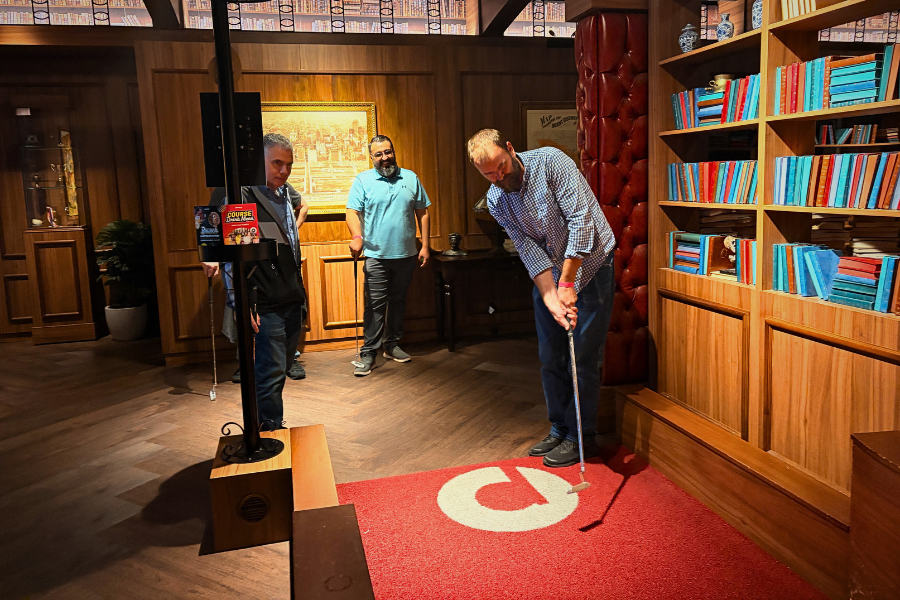 DMC engineers playing indoor minigolf